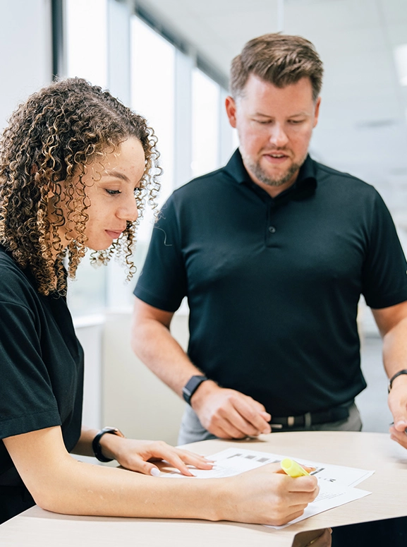 woman and man looking at forms for renting a vehicle in Buffalo
